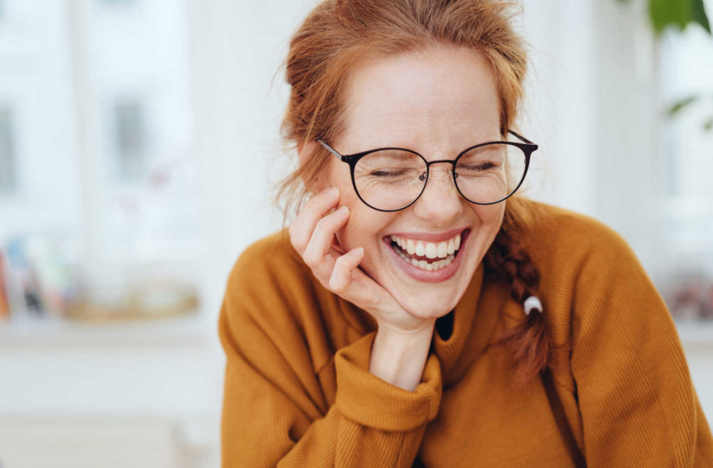 A smiling woman wearing glasses that fit comfortably and securely in the bridge of her nose