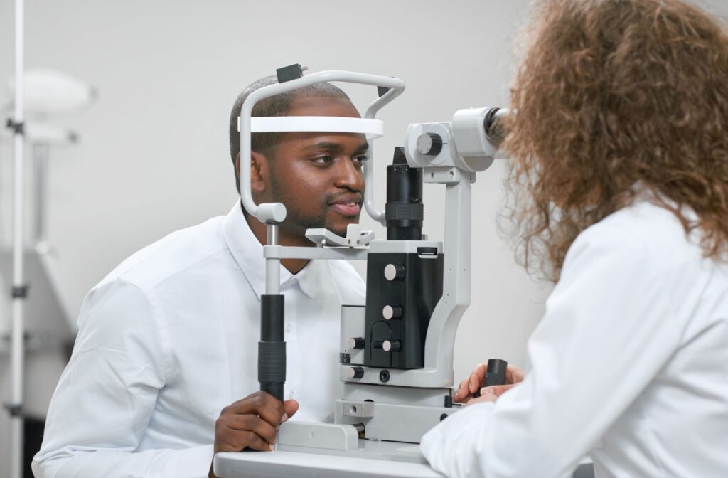 Patient undergoing a comprehensive eye exam with optometrist to assess eye alignment