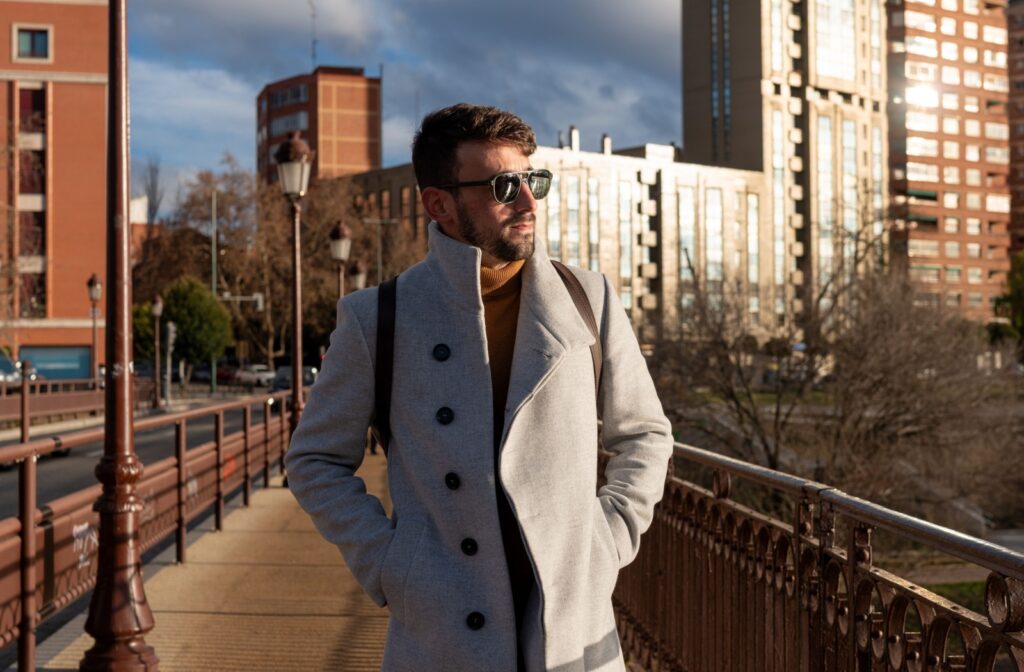 A person wearing sunglasses during fall to protect their vision during seasonal shifts.